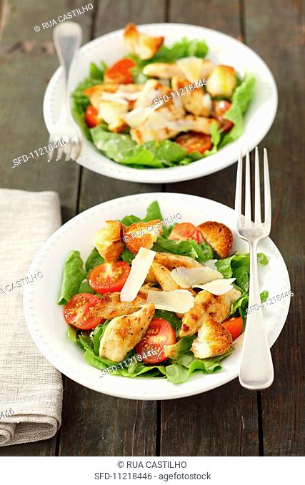 Caesar salad with chicken and tomatoes