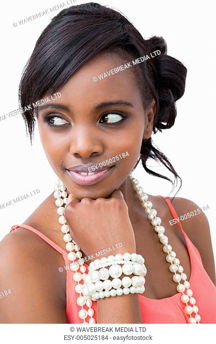 Smiling woman with pearl necklace and bracelet on white background