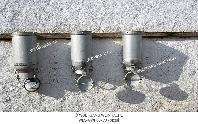 Austria, Salzburger Land, Milk cans on wall