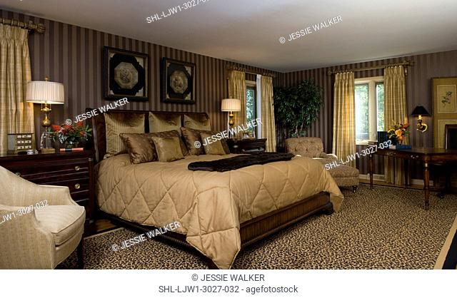 MASTER BEDROOMS: Elegant, gold toned warm neutrals, rich color, brown and gold striped wallpaper, gold bedding, fur throw, leopard area rug