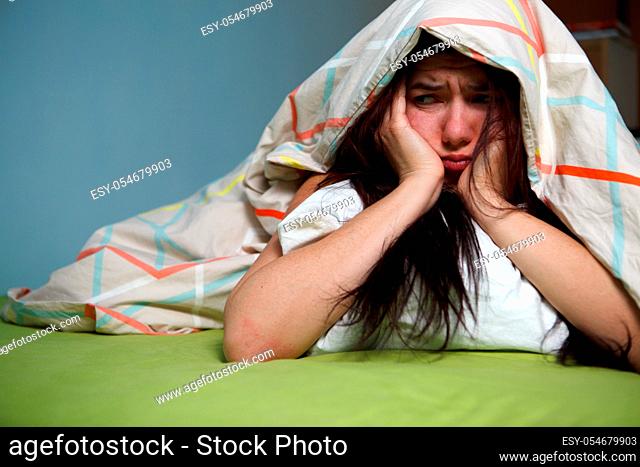 Woman with blanket under her head. Insomnia concept