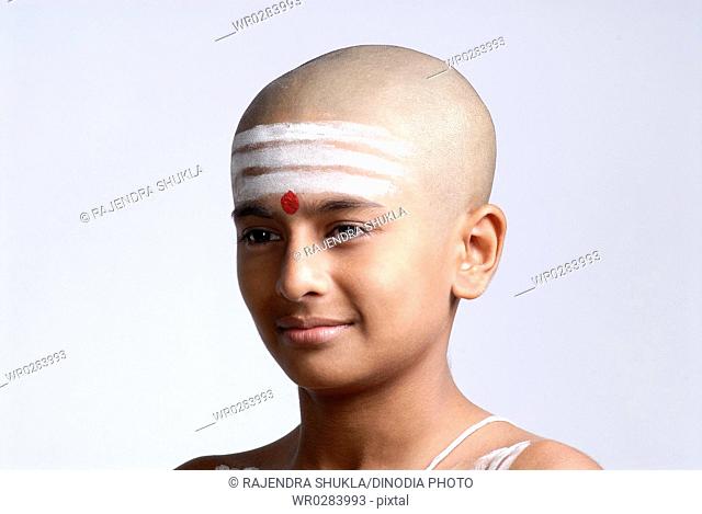 Portrait of South Asian Indian bald boy red tilak on forehead MR719