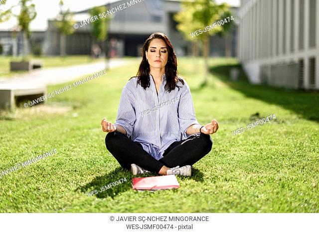 Portrait of student doing yoga exercices on campus