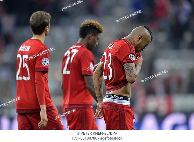 Munich's Thomas Mueller (L-R), David Alaba and Arturo Vidal react after the UEFA Champions League semi final second leg soccer match between Bayern Munich and...
