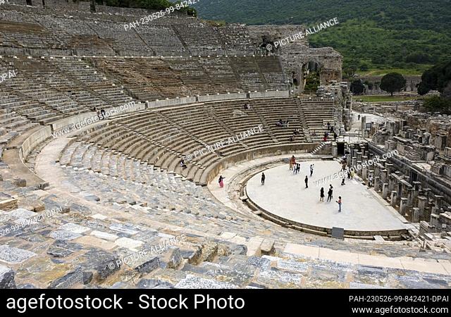 PRODUCTION - 11 May 2023, Turkey, Selcuk: Tourists visit the ancient city of Ephesus with the Great Theater. It was a metropolis of the Aegean region in ancient...