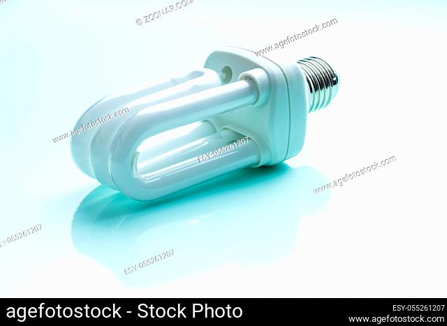 Energy saving light bulb on colorful background