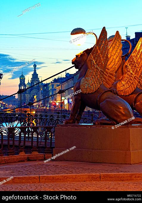 Sunset landscape with white night view of Saint-Petersburg. Famous place Bank bridge with griffins