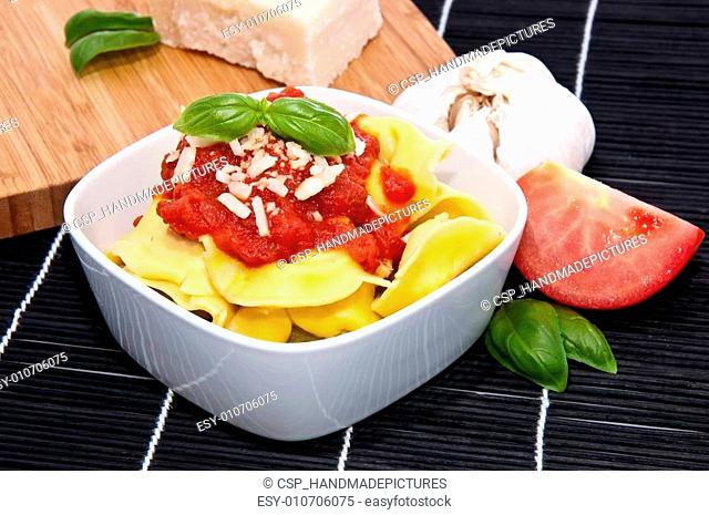 Tortellini in a bowl with ingredients