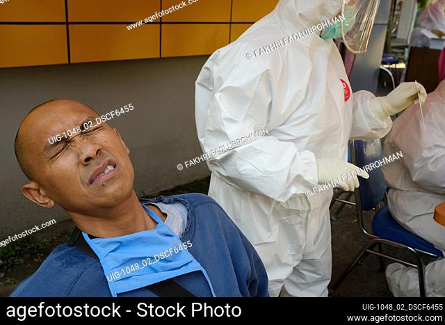 A health worker performs a coronavirus disease (COVID-19) nasal swab test in the Health Office of Bandung, West java, Indonesia, May 16, 2020
