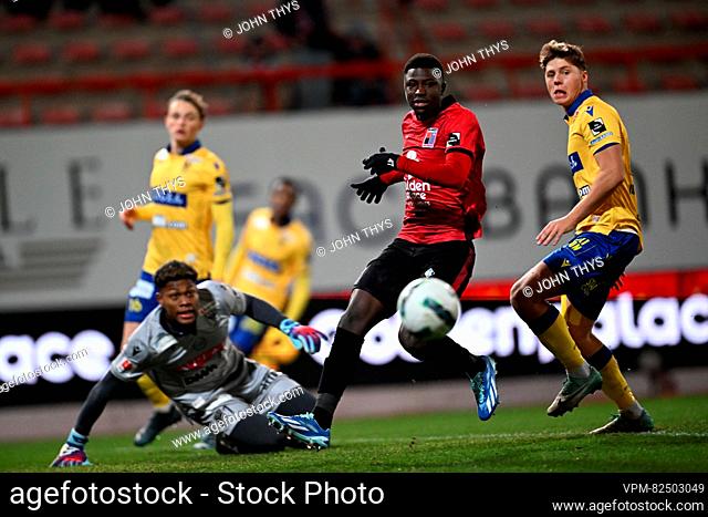 Rwdm's Pathe Mboup and STVV's goalkeeper Zion Suzuki fight for the ball during a soccer match between RWD Molenbeek and Sint-Truidense VV