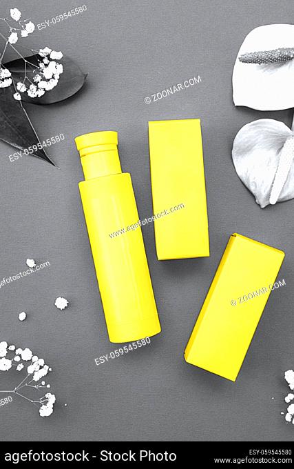 Colors of the year 2021: Ultimate Gray and Illuminating yellow concept. Makeup cosmetic products, flat lay, top view