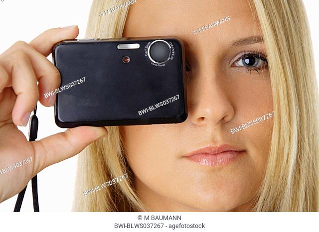 young, blond woman looking through camera