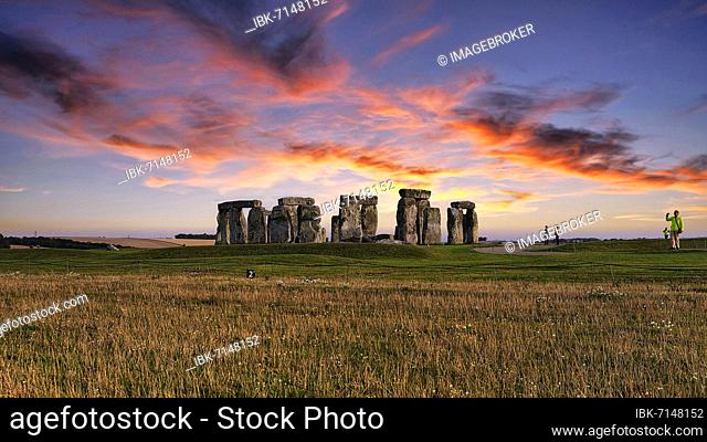 Stonehenge, Neolithic stone circle with visitors at sunset, Salisbury Plain, Wiltshire, England, United Kingdom, Europe