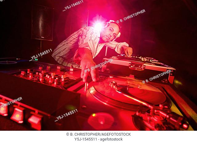 A night club DJ spinning a vinyl record