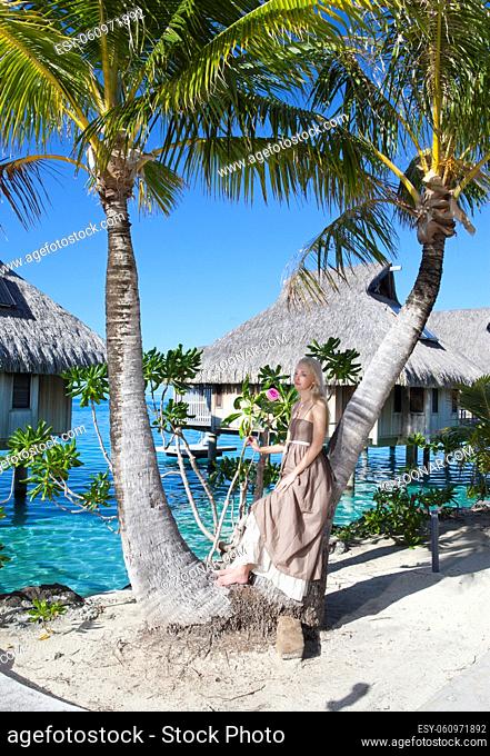 beautiful woman with a rose near a palm tree, Tahiti