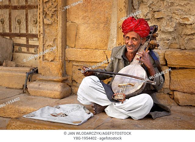 Portrait of a street indian musician man wearing a red turban, Jaisalmer, Rajasthan, India