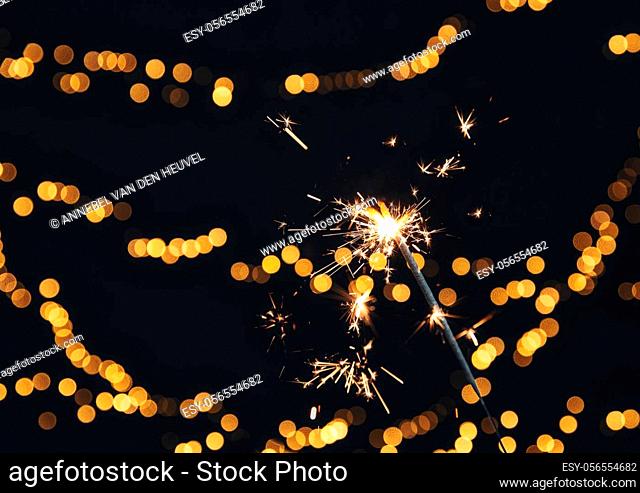 Burning Sparkler with Festive bokeh background for New Year and Christmas concept, space for text colorful design