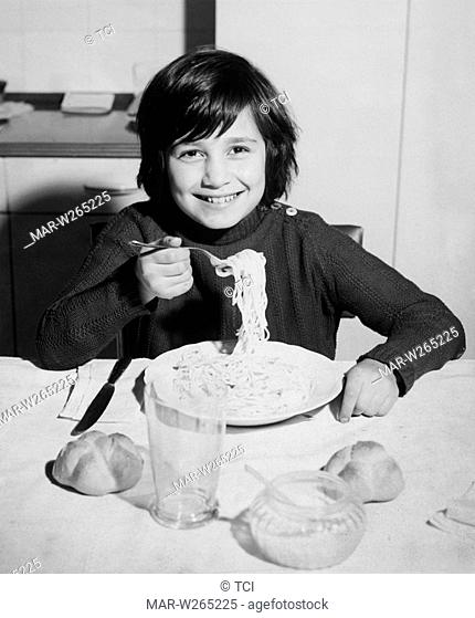 little boy eating spaghetti, 1962