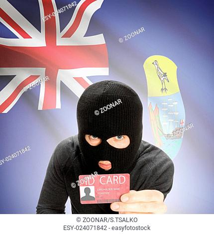 Hacker with flag on background holding ID card in hand - Saint Helena