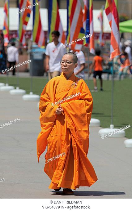 Buddhist nun wearing an orange robe during the festival of Vesak in Mississauga, Ontario, Canada. Vesak (Wesak) commonly known as Lord Buddha's birthday...