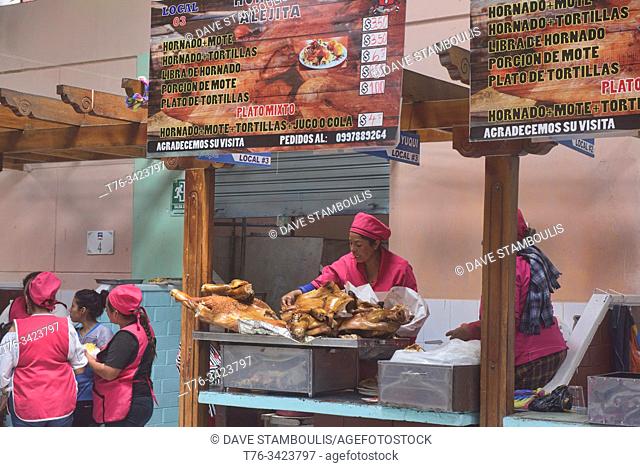 """""Hornado"" roast pork sellers in La Merced Market, Riobamba, Ecuador