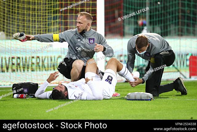 Anderlecht's Elias Cobbaut lies injured on the ground during a soccer match between KV Oostende and RSC Anderlecht, Friday 28 August 2020 in Oostende