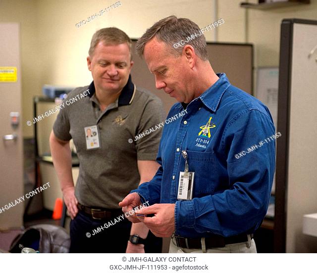 NASA astronauts Steve Lindsey (right), STS-133 commander; and Eric Boe, pilot, participate in an ISS tools and repair kits training session in the Space Vehicle...