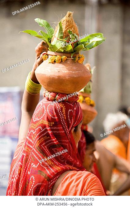 Woman holding ritual pot, kumbh mela, ujjain, madhya pradesh, india, asia