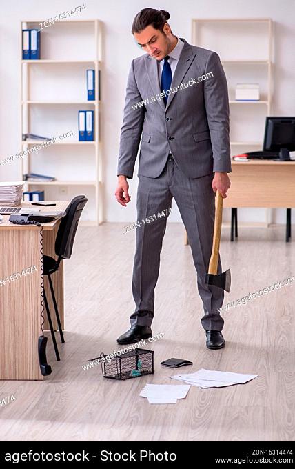 Male employee and mousetrap in the office