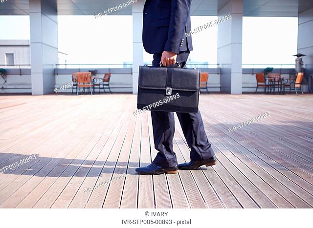 Asian Businessman Holding Briefcase