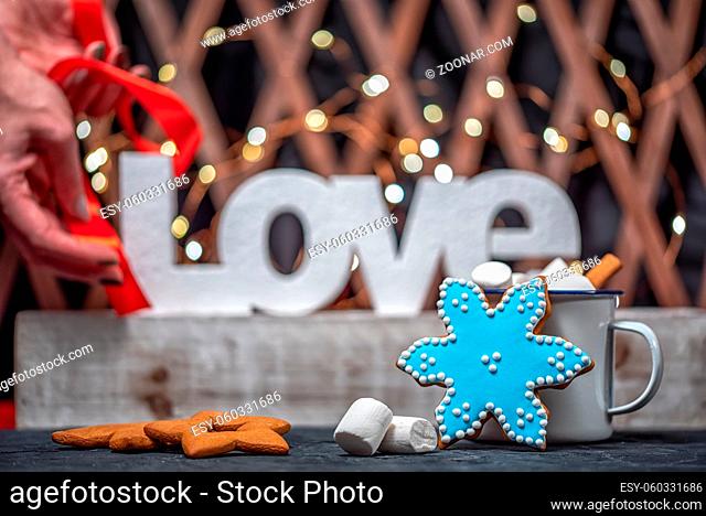 Bright christmas background with gingerbreads and white letters of word love