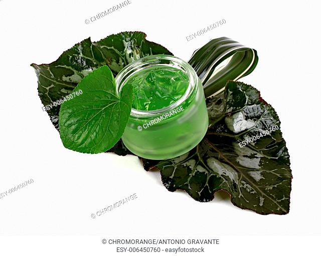 Cosmetics cream in the green jar on white background