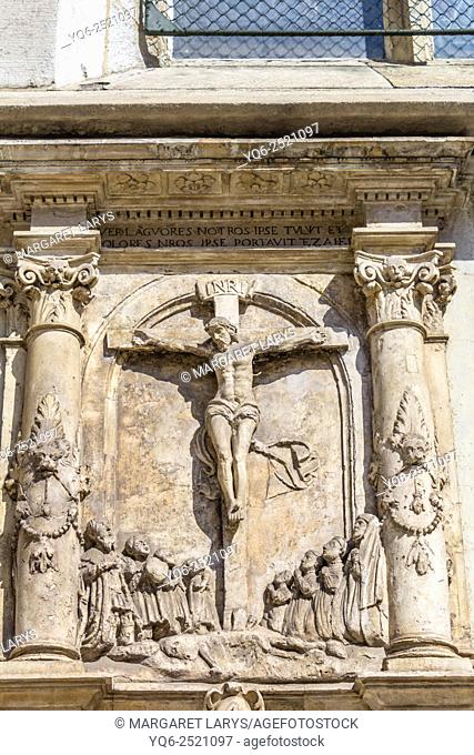 Jesus Christ on the cross, details of architecture on Mariacki church in Krakow, Poland