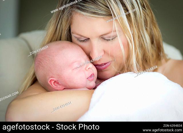 Young Caucasian Beautiful Mother Holding Her Precious Newborn Baby Girl