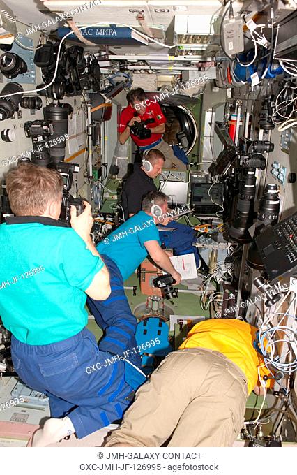 Expedition 27 crew members are busy at work in the Zvezda Service Module of the International Space Station during rendezvous and docking activities of the ISS...