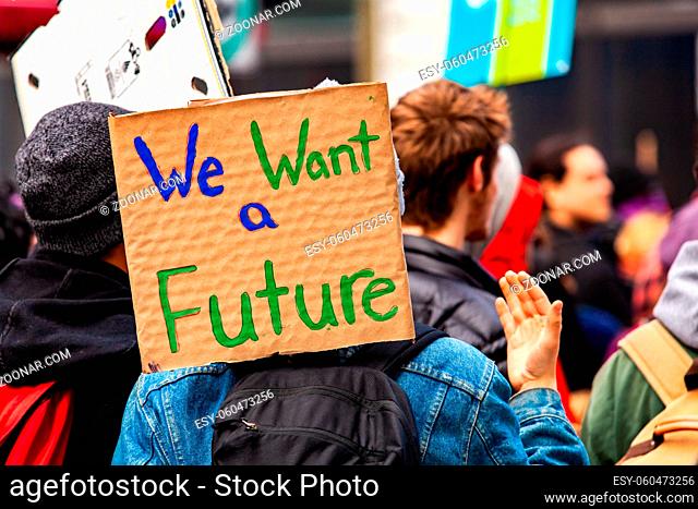 A cardboard sign is viewed close-up saying we want a future as a crowd of environmental campaigners march against climate change in Montreal, Canada