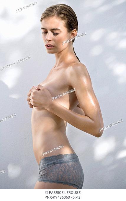 Woman hiding her breast with her hands