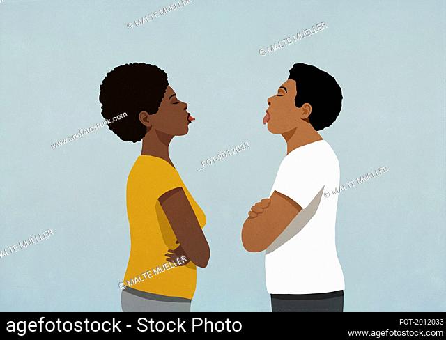 Couple standing face to face, sticking tongues out