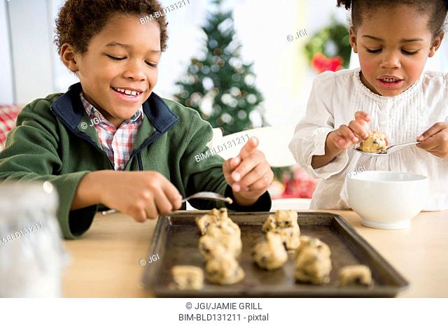 Black children baking cookies together