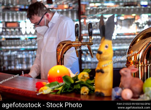 22 March 2021, Mecklenburg-Western Pomerania, Koserow: Easter decorations stand on the counter in one of the restaurants at the ""Hanse Kogge"" hotel in Koserow...