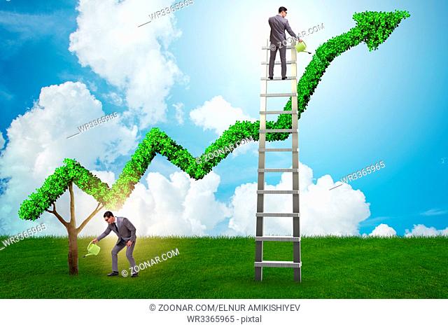 Businessman in investment concept watering financial line chart
