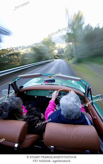 Retired couple driving their Classic 1959 Porsche 356A Cabriolet