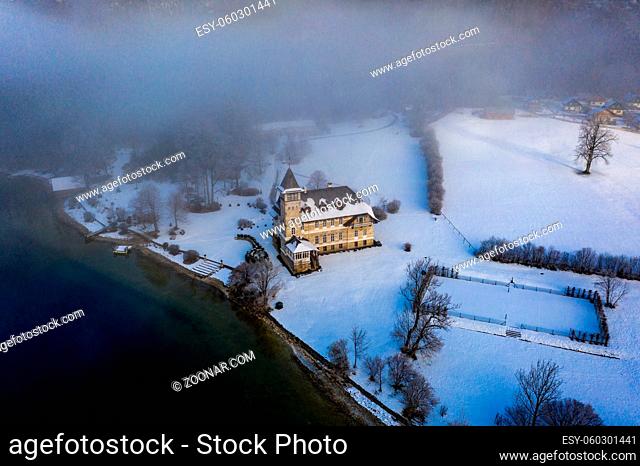 Winter Lake and snowy Forest Landscape Travel foggy serene scenic aerial view - Grundlsee in Austria