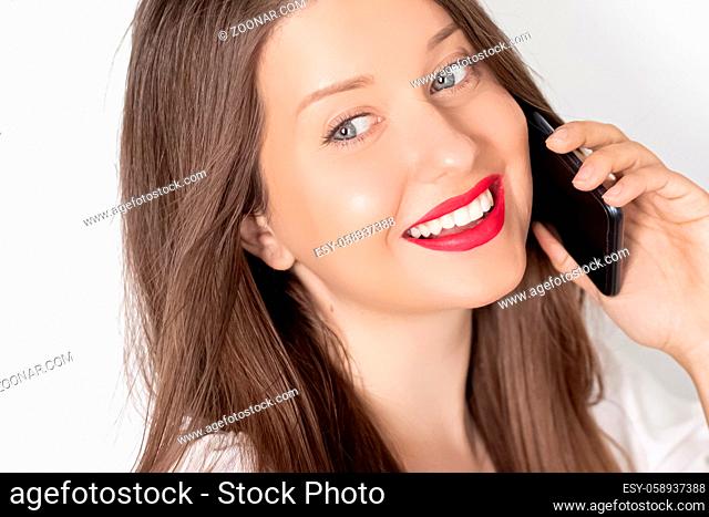 Happy smiling woman calling on smartphone, portrait on white background. People, technology and communication concept