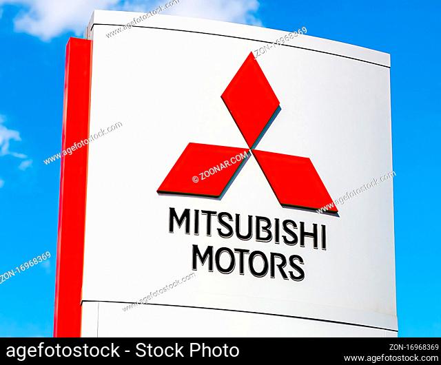 Samara, Russia - May 11, 2016: Mitsubishi logo on a sign outside the car or automotive dealership against the blue sky