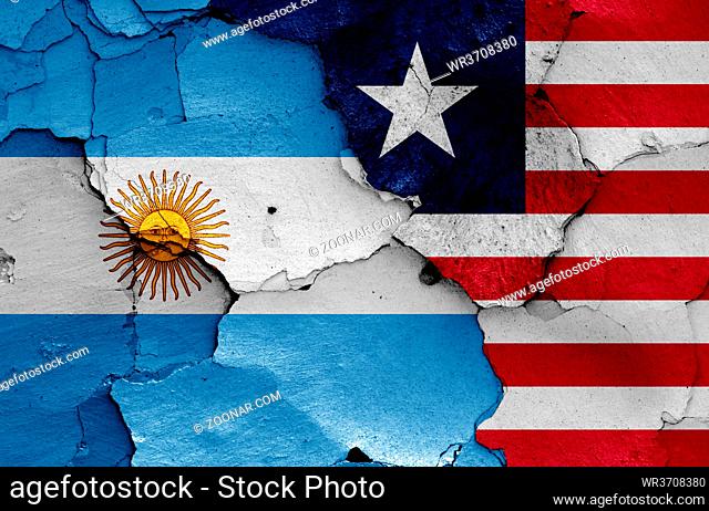 flags of Argentina and Liberia painted on cracked wall