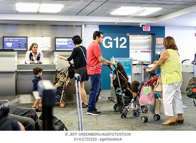 Florida, Miami, Miami International Airport, MIA, aviation, terminal, concourse, gate, flight, departure, counter, Frontier Airline, agent, Hispanic, man, woman