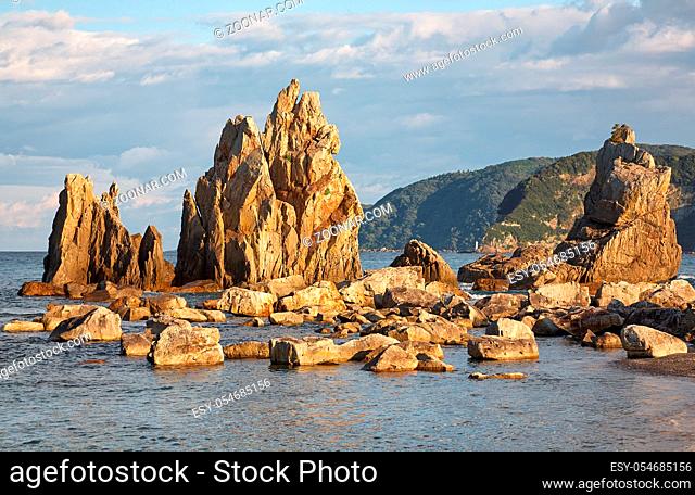Hashigui-iwa (Bridge Pillar Rocks) - the series of rocks leading towards Oshima Island near Kushimoto at the sunset light. Wakayama prefecture. Honshu