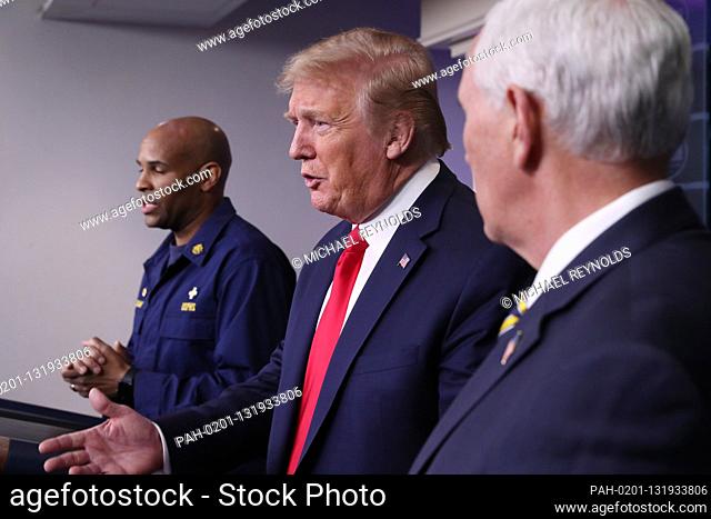 US President Donald J. Trump (C) and US Vice President Mike Pence (R) listen as US Surgeon General Jerome Adams (L) and members of the Coronavirus Task Force to...