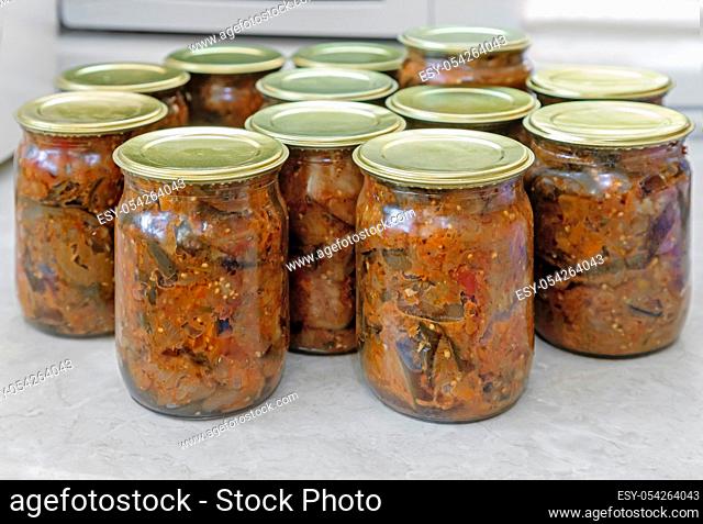 Home canning: small glass bottles with canned vegetables, which were closed with metal lids